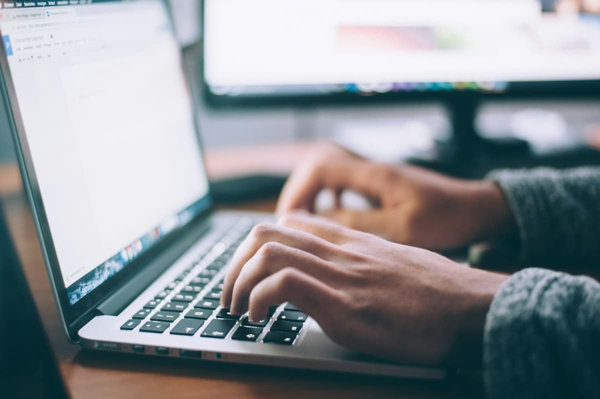 Person working on a laptop at a clean desk