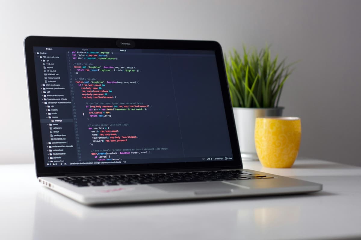 Laptop with code on a wooden desk